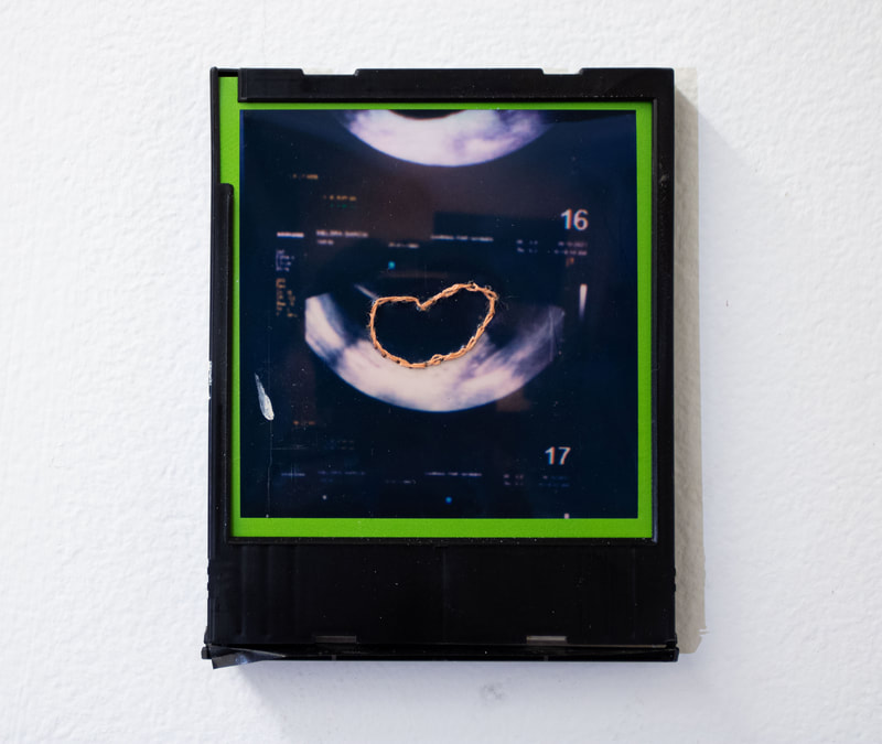 Melora Garcia</br>
untitled</br>
2022</br>
embroidered polaroid 600 film in plastic cartridge</br> 
$150.00